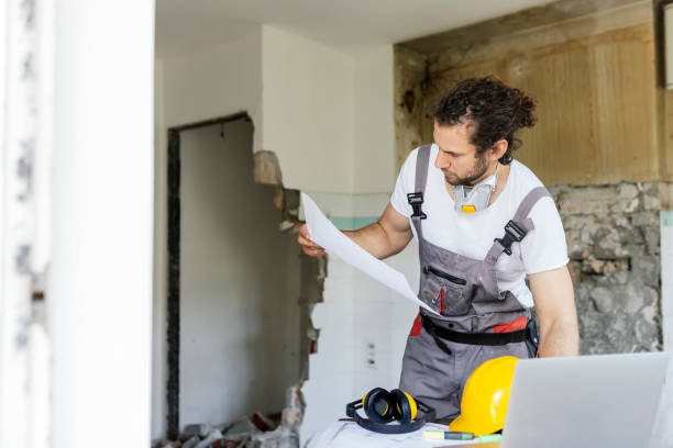 Professional contractor from the best remodeling company in Santa Clarita reviewing home renovation plans on a laptop