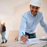 Expert remodeling contractor in Hollywood working on a laptop at a construction site, planning home renovation projects