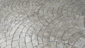 A concrete patio with a distinct circular design, emphasizing contemporary patio design, outdoor construction, and modern aesthetics for a stylish and functional space.