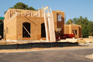  A large house under construction, showcasing custom remodeling work in progress.