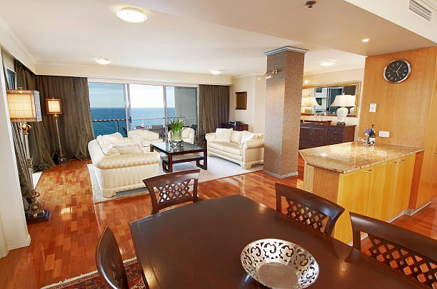 A stylish living room and dining area featuring a stunning ocean view, showcasing custom remodeling details.